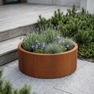 Round corten steel planter with a natural rust patina, featuring a folded top edge and 120 cm circumference, planted with lavender and ornamental grasses in a modern Scandinavian garden setting.